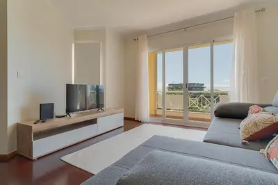 a living room with a couch and a television at Sao Joao- 3 Bedroom apartment in Funchal