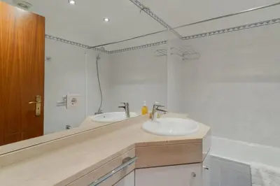 a bathroom with two sinks and a large mirror at Sao Joao- 3 Bedroom apartment in Funchal