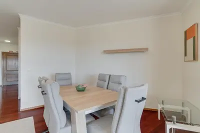 a dining room with a wooden table and chairs at Sao Joao- 3 Bedroom apartment in Funchal