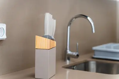 a knife block on a counter next to a sink at GuestReady - Typical experience in Funchal in Funchal