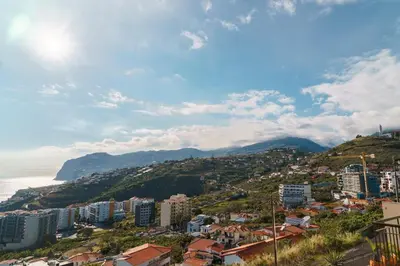 a city on a hill next to the ocean at GuestReady - Typical experience in Funchal in Funchal