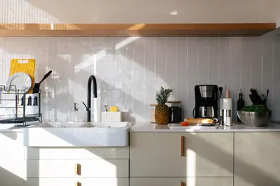 a kitchen with white counters and a sink at Outsite Sagres - Work, Connect, Explore in Sagres