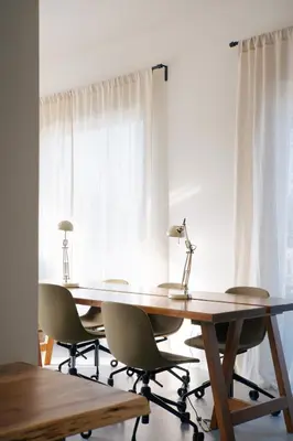 a table and chairs in front of a window at Outsite Sagres - Work, Connect, Explore in Sagres