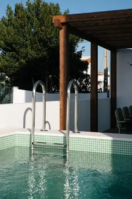 a swimming pool with two metal faucets in the water at Outsite Sagres - Work, Connect, Explore in Sagres