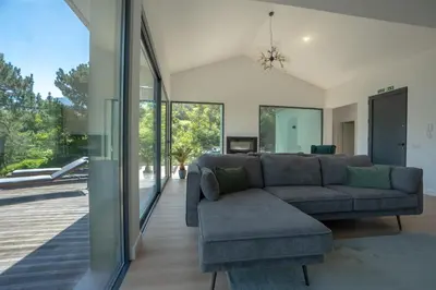 a living room with a couch and a chair at Panorama House by LovelyStay in São Vicente