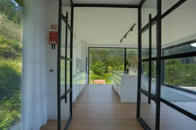 a hallway of a house with glass doors at Panorama House by LovelyStay in São Vicente