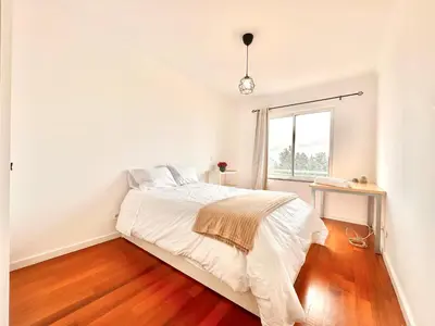 a white bedroom with a bed and a window at Edna 1 in Funchal