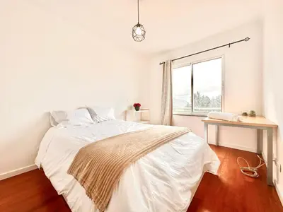 a white bedroom with a bed and a window at Edna 1 in Funchal