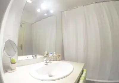 a white bathroom with a sink and a mirror at Edna 1 in Funchal