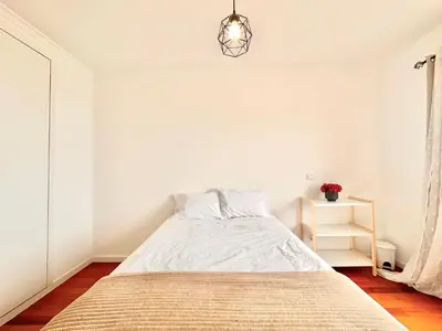 a bedroom with a bed and a pendant light at Edna 1 in Funchal