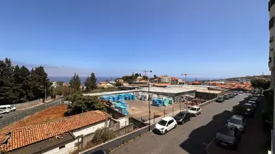 a view of a parking lot with a swimming pool at Edna 1 in Funchal