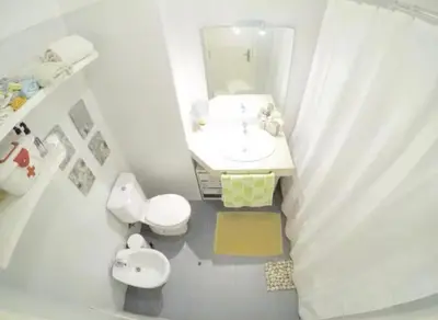a bathroom with a sink and a toilet and a mirror at Edna 1 in Funchal
