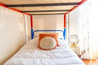 a bedroom with a bed with a blue and red frame at Sounds of Nature in Santana