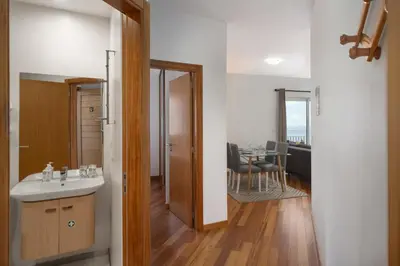 a bathroom with a sink and a room with a table at Alta Vista Caniço by An Island Apart in Santa Cruz