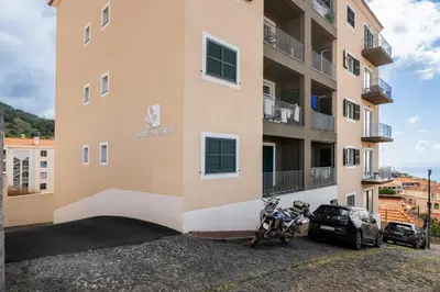 a motorcycle parked in front of a building at Alta Vista Caniço by An Island Apart in Santa Cruz