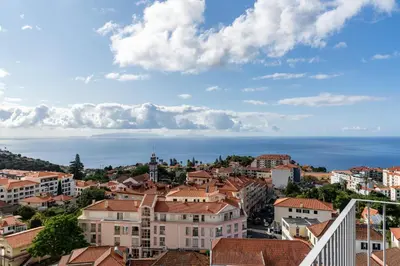 a view of a city with buildings and the ocean at Alta Vista Caniço by An Island Apart in Santa Cruz
