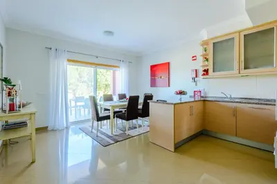 a kitchen and dining room with a table and chairs at Casa Maria at Boavista Resort Lagos in Atalaia