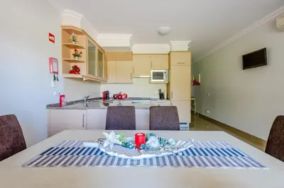 a kitchen and dining room with a table and chairs at Casa Maria at Boavista Resort Lagos in Atalaia