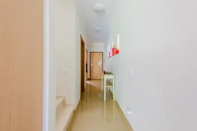 a hallway with white walls and a glass table at Casa Maria at Boavista Resort Lagos in Atalaia