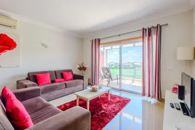 a living room with a couch and a table at Casa Maria at Boavista Resort Lagos in Atalaia