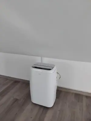 a white trash can sitting in the corner of a room at MM House in Bicas