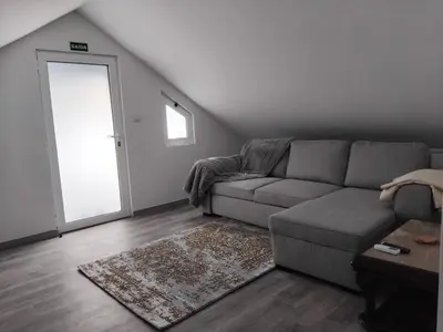 a living room with a couch and a window at MM House in Bicas