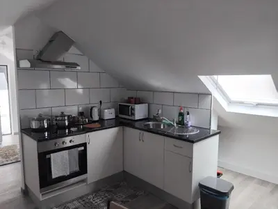 a small kitchen with a stove and a sink at MM House in Bicas