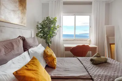 a bedroom with a bed with a teddy bear on it at Ti Clara View Apartment in Caniço