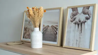 a white vase sitting on a shelf with two pictures at Hygge Madeira by LovelyStay in Caniço