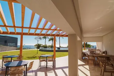 a patio with tables and chairs and a view of the ocean at GuestReady - Soothing escape in Funchal in Funchal