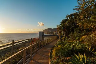 a walkway next to the ocean with a fence at GuestReady - Soothing escape in Funchal in Funchal