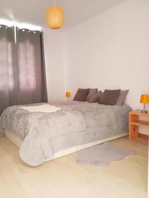 a bedroom with a large bed and a table at Honey Factory House in Santa Cruz