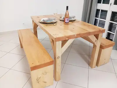 a wooden table and bench with a bottle of wine at Honey Factory House in Santa Cruz