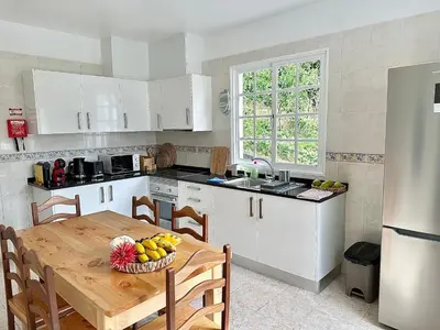 a kitchen with a table with a bowl of fruit on it at Honey Factory House in Santa Cruz