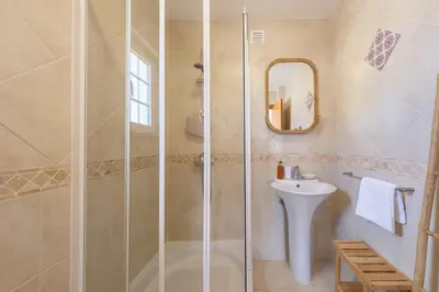 a bathroom with a shower and a sink at Villa Oxalis by Destination Algarve in Atalaia