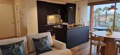 a living room with a kitchen and a table with a dining room at Shell Living - KOS in Funchal