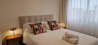 a bedroom with a large bed with two pillows at Shell Living - KOS in Funchal