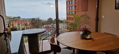 a room with a table and a balcony with a view at Shell Living - KOS in Funchal