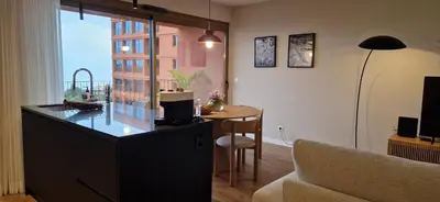 a living room with a kitchen with a table and a couch at Shell Living - KOS in Funchal