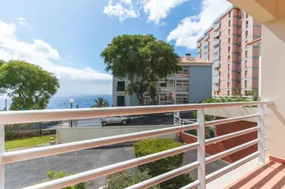 a balcony with a view of the ocean at Strelitzia Apartment by AH in Caniço