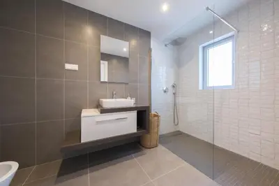 a bathroom with a sink and a glass shower at Beach Condominium 27 by Destination Algarve in Santo Amaro