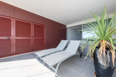 a room with chairs and a potted plant at Beach Condominium 27 by Destination Algarve in Santo Amaro