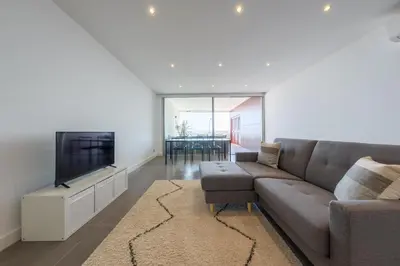 a living room with a couch and a flat screen tv at Beach Condominium 27 by Destination Algarve in Santo Amaro