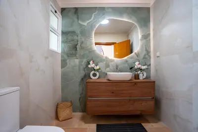 a bathroom with a sink and a mirror at BravaSol by LovelyStay in Tábua