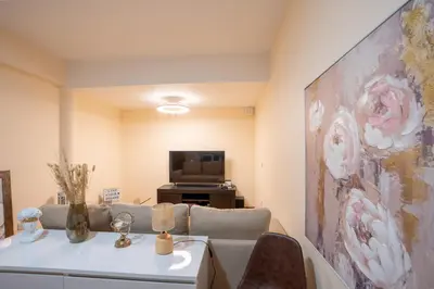 a living room with a couch and a tv at BravaSol by LovelyStay in Tábua