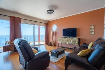 a living room with two couches and a television at BravaSol by LovelyStay in Tábua