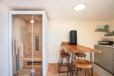 a small kitchen with a table and stools at BravaSol by LovelyStay in Tábua