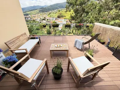 a patio with two chairs and a table with a view at 10 min to Calheta Beach - Apartamento Da Natureza - KING Size Bed - LARGE Terrace in Arco da Calheta