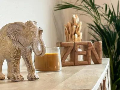 a figurine of an elephant next to a glass of orange juice at 10 min to Calheta Beach - Apartamento Da Natureza - KING Size Bed - LARGE Terrace in Arco da Calheta