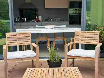 a kitchen with two wooden chairs and a table at 10 min to Calheta Beach - Apartamento Da Natureza - KING Size Bed - LARGE Terrace in Arco da Calheta
